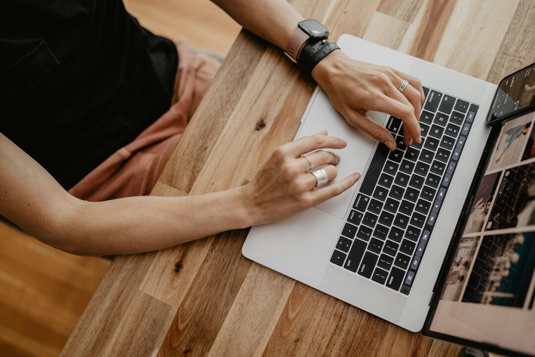 writer typing on laptop at desk