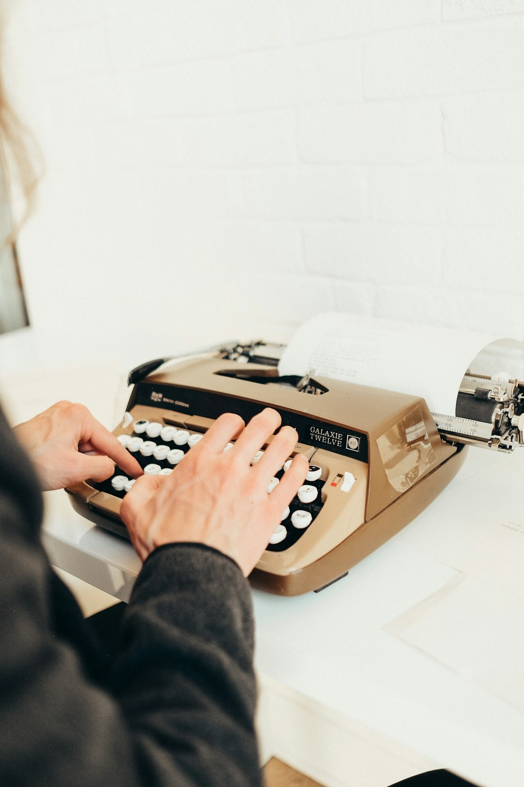 writer typing on typewriter