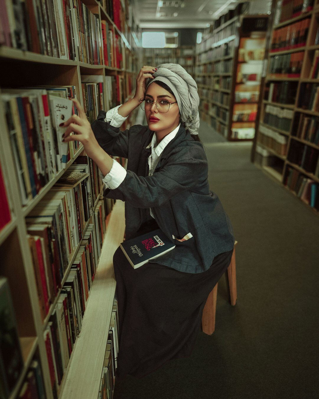 detective reading book in library
